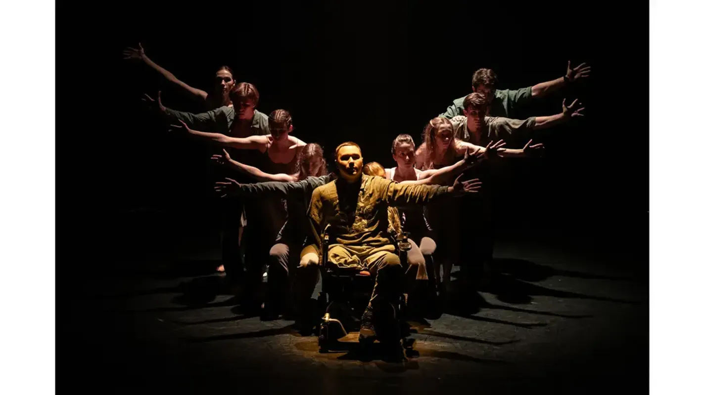 Official Singer Laren gala photograph showing a stage ensemble with outstretched arms around a seated performer.