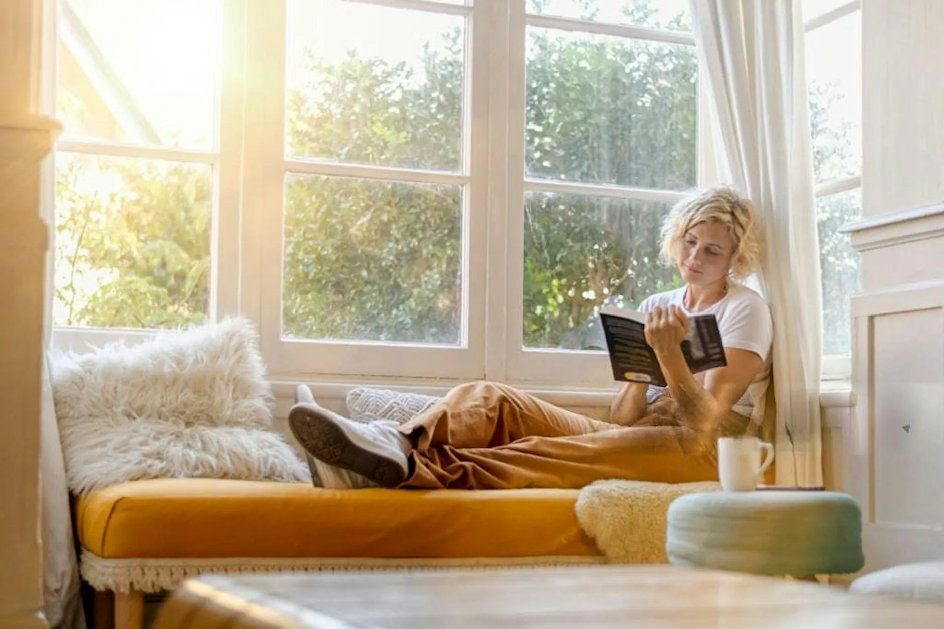 Woman reading by a window; organiser-selected image for the MUDRA Book Club November Eventbrite page.