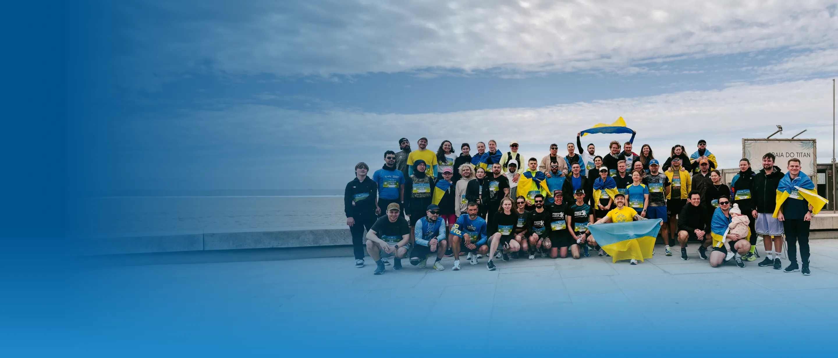 Runners with Ukrainian flags in official Children of Heroes campaign artwork; not a photograph of the forthcoming Rotterdam event.
